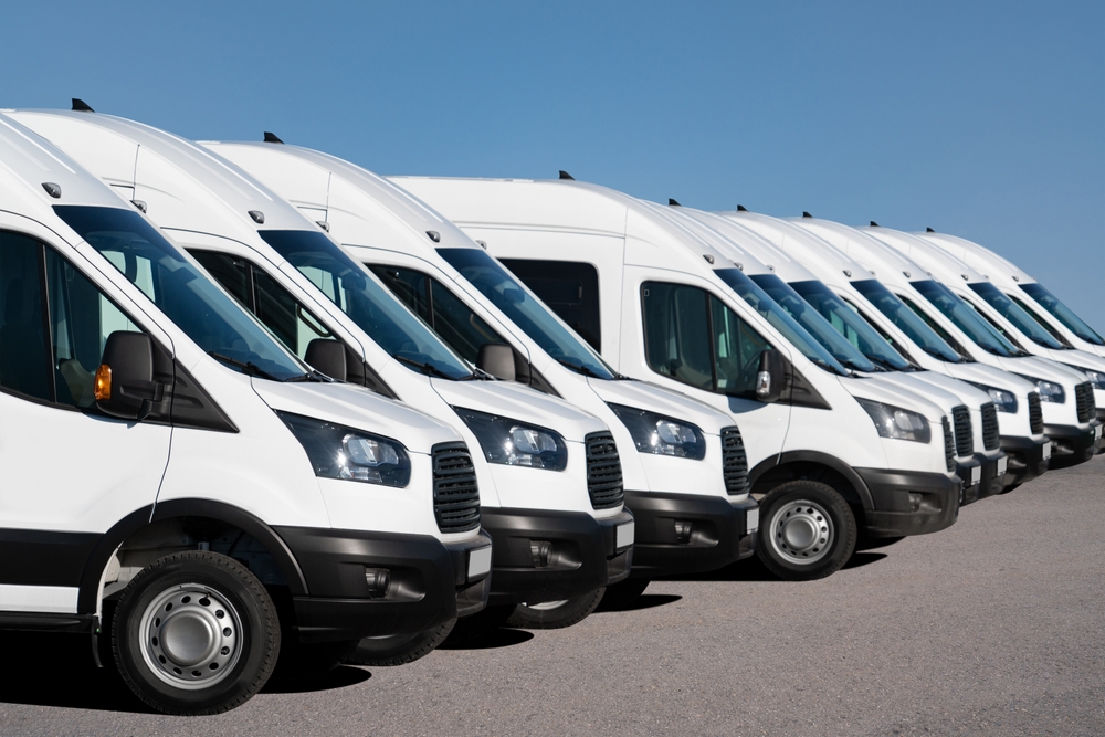 Line of white light commercial vehicles ready for fleet deployment